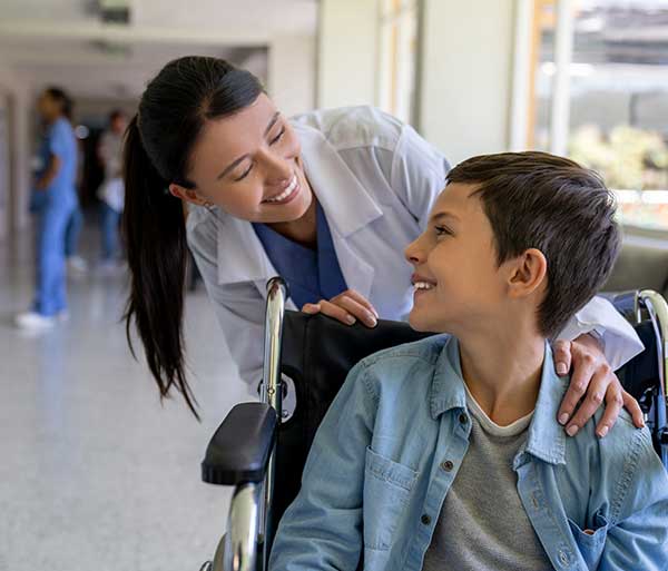 boy with nurse in wheelchair